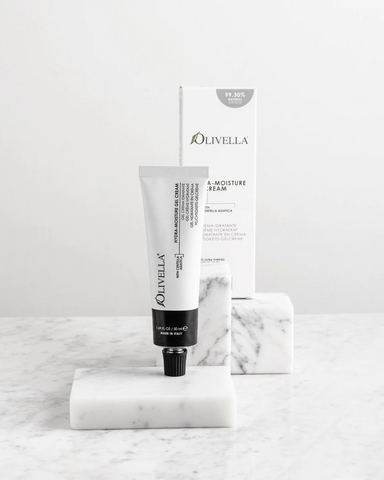 Olivella skincare product on a marble surface with a white background